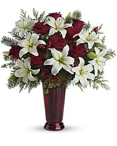 Christmas flowers with lilies, roses, berries and greenery for Christmas flowers delivery.