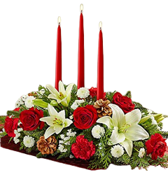 Christmas centerpiece with roses, lilies, carnations and pines for Christmas flowers delivery.